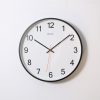 round analog wall clock pointing at 10:09