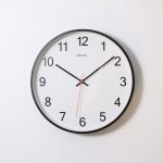 round analog wall clock pointing at 10:09